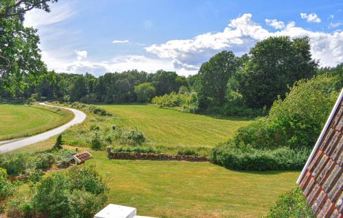 a view of a grassy field next to a road at Cozy Home In Mörrum With Wifi in Mörrum