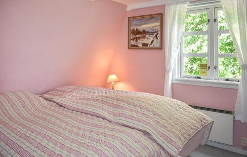a bedroom with a bed and a window at Cozy Home In Mörrum With Wifi in Mörrum