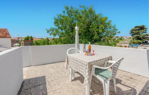 a table and two chairs sitting on a patio at Stunning Apartment In Nin With Wifi in Nin