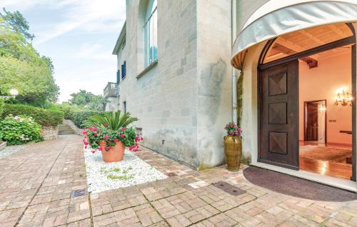 a house with two potted plants next to a door at 1 Bedroom Lovely Apartment In Grimaldi in Grimaldi