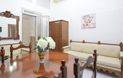 a living room with a couch and a table with flowers at Beautiful Apartment In Ragusa With Wifi in Ragusa