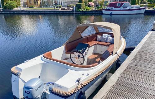 a boat tied up to a dock on the water at 3 Bedroom Gorgeous Home In Lemmer in Lemmer