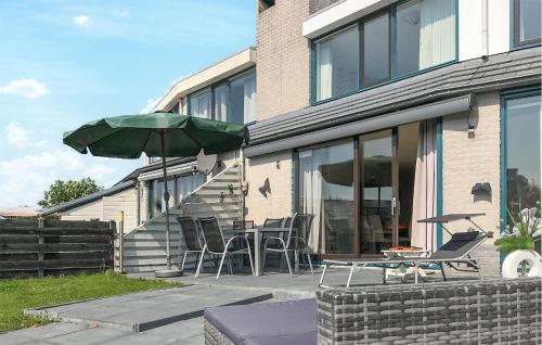 a patio with a table and chairs and an umbrella at 3 Bedroom Gorgeous Home In Lemmer in Lemmer