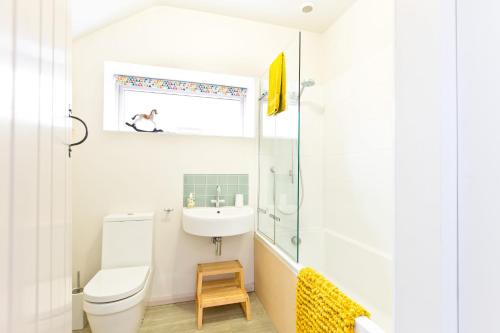 a bathroom with a toilet and a sink at Edge Cottage in Curbar