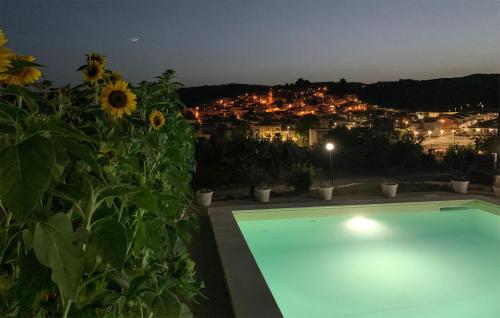 a swimming pool with a view of a city at night at Cozy Home In Giarratana With Wifi in Giarratana