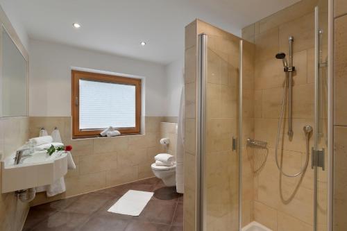 une salle de bain avec douche et toilettes dans l'établissement Haus Adler by Alpine Host Helpers, à Westendorf