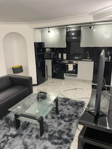 un salon avec un canapé et une table en verre dans l'établissement Appartement design au coeur de Paris, à Paris