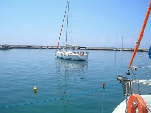 a boat is docked in a large body of water at POLA HOME in Nea Skioni