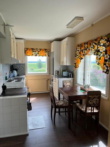 a kitchen with a table and a dining room at Beautiful Big Farm House with Spectacular Meteor Site View in Vaasa