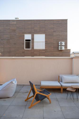 a living room with a bench and a table at ETERN Apart-Hotel II in Pristina