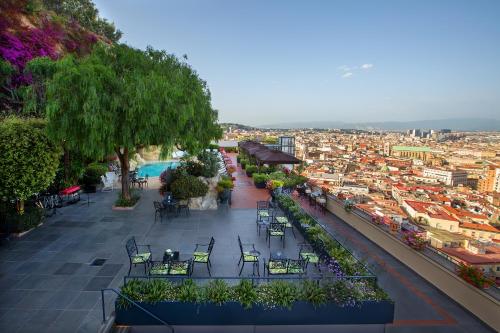 a balcony with tables and chairs and a view of a city at San Francesco al Monte in Naples
