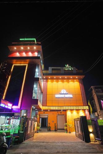 a building with lights on it at night at PS Luxury Hotel in Baharampur