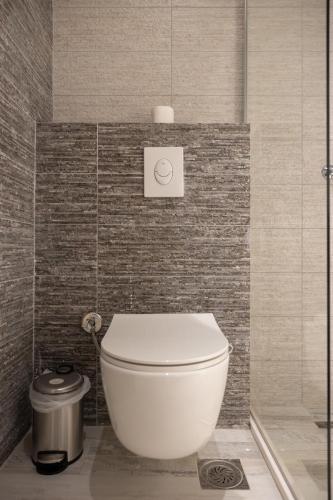 a bathroom with a white toilet in a room at ETERN Apart-Hotel II in Pristina