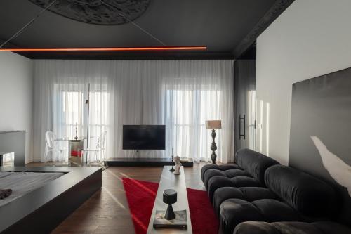 a living room with a couch and a television at ETERN Apart-Hotel II in Pristina