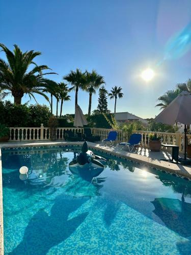 a person in a raft in a swimming pool at Casa Sofia in Calpe