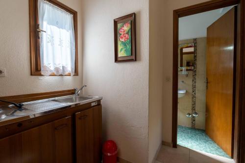 a bathroom with a sink and a shower at Guesthouse Papachristou in Tsagarada