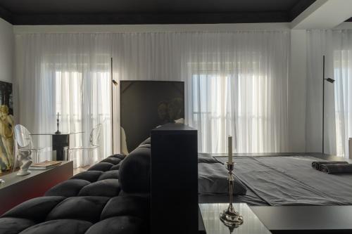 a bedroom with a bed with white curtains at ETERN Apart-Hotel II in Pristina