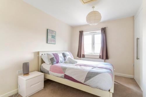 a bedroom with a bed and a window at Lovely Two Bed detached house with Parking in Tipton