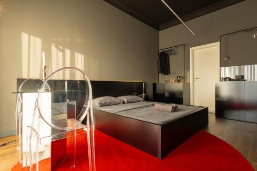 a bedroom with a bed and a red rug at ETERN Apart-Hotel II in Pristina