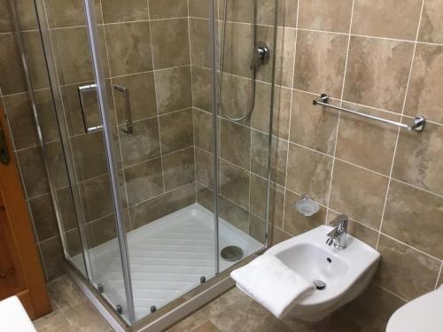 a bathroom with a shower and a sink at S' Agrùstu in Orosei