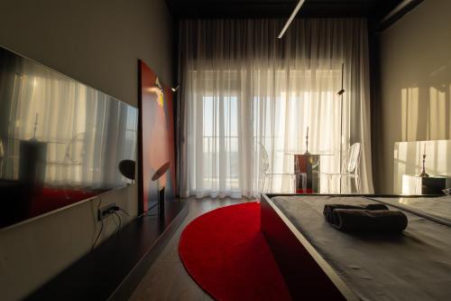 a bedroom with a bed and a red rug at ETERN Apart-Hotel II in Pristina