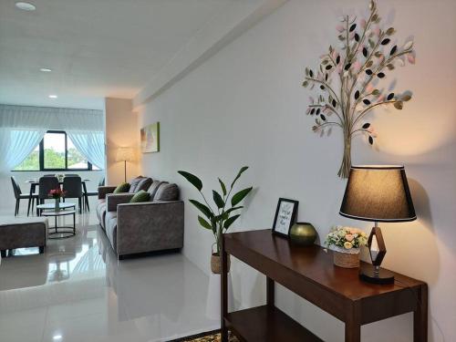a living room with a couch and a table with a lamp at Kafaz2-Kpg Patingan 3Bedroom 3 Bathroom -first floor in Kuching