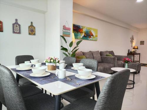 a dining room table with chairs and a couch at Kafaz2-Kpg Patingan 3Bedroom 3 Bathroom -first floor in Kuching