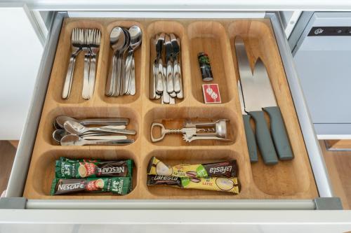 a drawer filled with utensils in a kitchen at SkyPenthouse & SPA with FREE Parking in Rīga