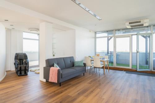 a living room with a couch and a table at SkyPenthouse & SPA with FREE Parking in Rīga