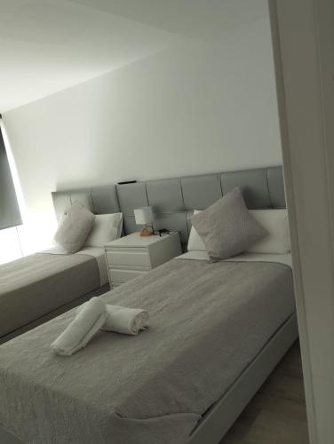 a bedroom with a bed with a white headboard at Hotel Serenity Platja d'Aro by Pandora Hoteles in Platja d'Aro