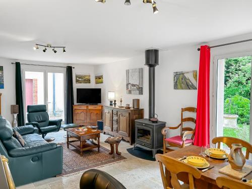 a living room with a table and a fireplace at Nature et Bord d'Etang à Jars in Jars
