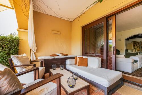 a living room with a couch and a table at Villa Rokkaria in Villasimius