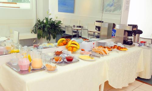 a table with plates of food and fruit on it at Aqua Hotel in Punta del Este