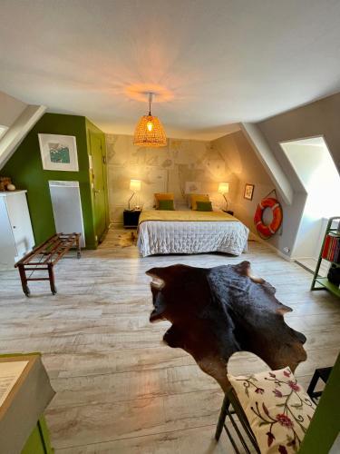 a bedroom with a king sized bed in a attic at Chambres De St Michel in Paimpol