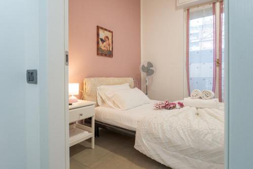 a bedroom with a bed and a desk and a window at Station's Apartments Bergamo in Bergamo