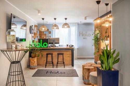 a kitchen with a counter and stools in a room at Halo Hel in Hel