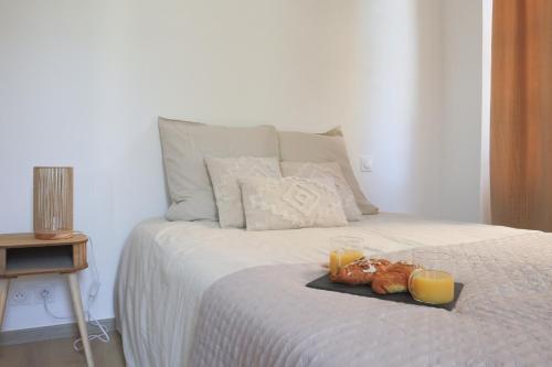 a tray of food on a bed with two candles at La Chambre Aux Anges in Wahlbach