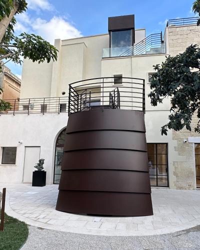 a spiral building with a balcony on top of it at Fiermonte Museum by La Fiermontina in Lecce