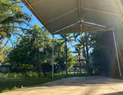 a pavilion in a park with palm trees and a tower at Samba Angra dos Reis in Angra dos Reis