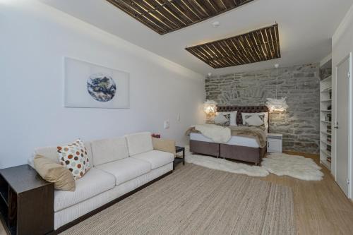 a living room with a couch and a bed at Tallinn Old Town Romantic Apartment in Tallinn