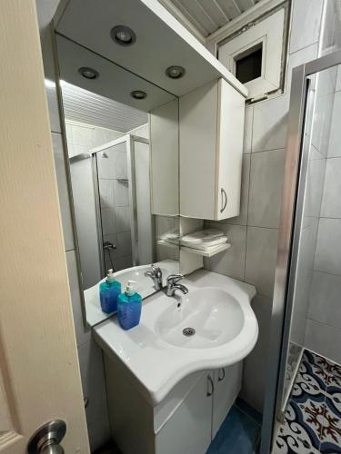 a bathroom with a white sink and a mirror at Bayındır Palme Hotel in Antalya