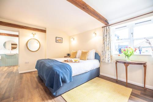 a bedroom with a large bed and a window at The Stables Valley Farm Barns, Snape in Saxmundham