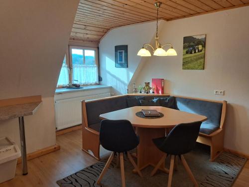 a dining room with a table and chairs and a window at BIO-Peisingerhof in Sankt Stefan ob Leoben