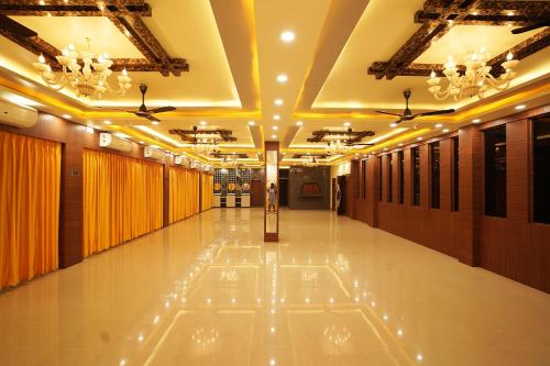 a large hallway with a ceiling with lights on it at PS Luxury Hotel in Baharampur
