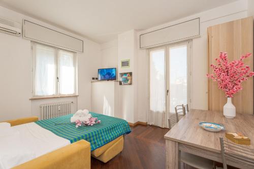 a bedroom with a bed and a table with a stuffed animal at Station's Apartments Bergamo in Bergamo