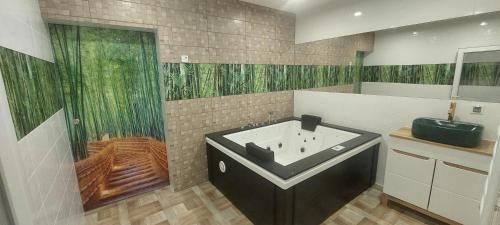 a bathroom with a bath tub and a sink at WILLA NA WYŁĄCZNOŚĆ 12 os BIESZCZADY z Salą Imprezową, Jacuzzi, Sauną, Balią Zewnętrzną oraz 2 baseny z podgrzewaną wodą - Rezydencja Matiaszówka in Polańczyk