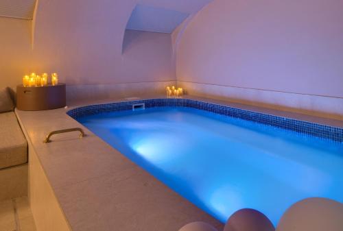 a large swimming pool with a blue lighting in a room at Hôtel Artemisia Montmartre in Paris