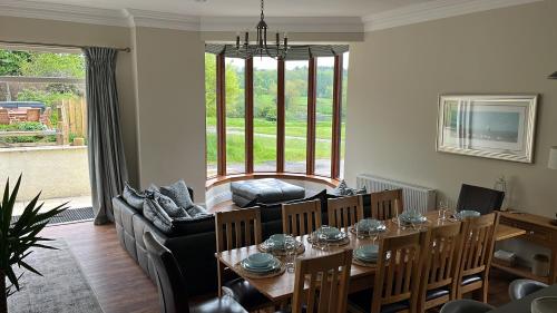 a living room with a table and a couch at The Farmhouse at Solsgirth Home Farm in Dollar
