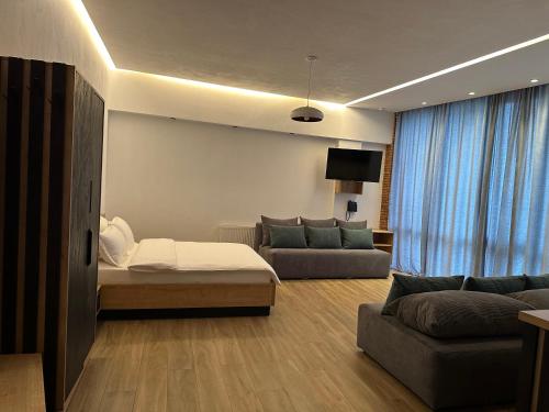 a living room with a bed and a couch and a tv at Chiko Group in Aspindza