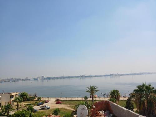 a view of the water with a bridge in the distance at شاليهات الهنا 3 للايجار مصيف قرية النورس الاسماعيلية in Ismailia